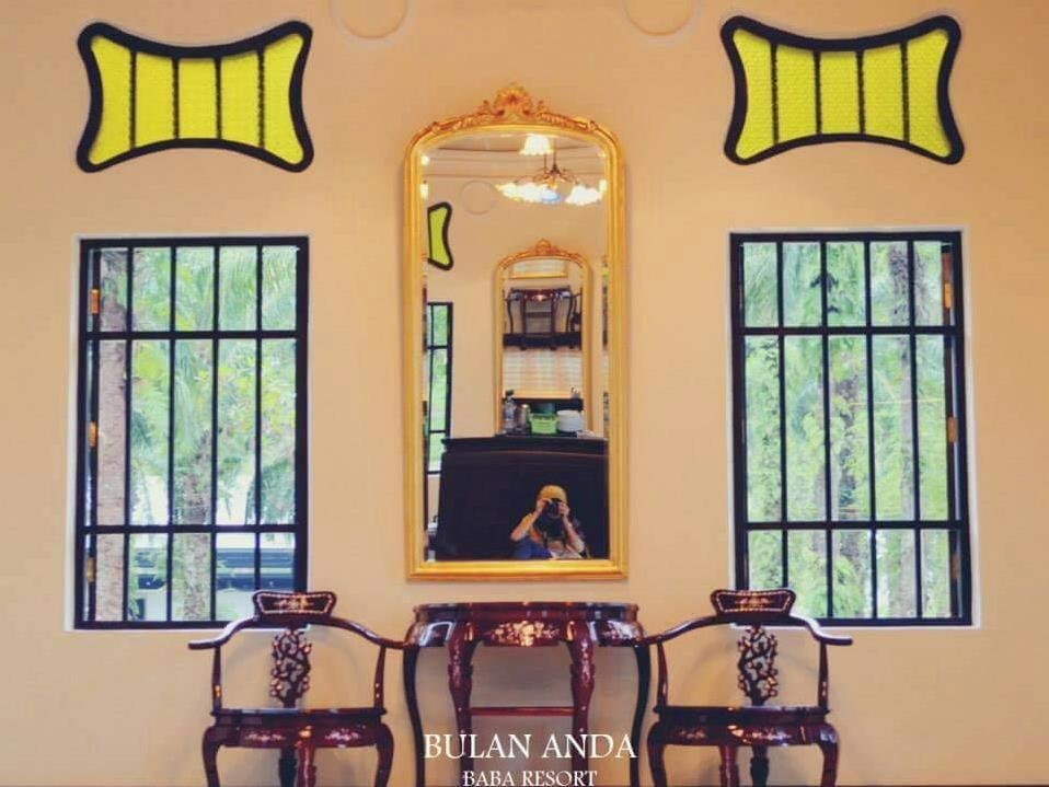 Decorative mirror and chairs inside Bulan Anda Baba Resort