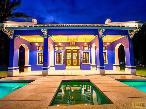 Colourful pavilion reflected in ornamental water features at Bulan Anda Baba Resort