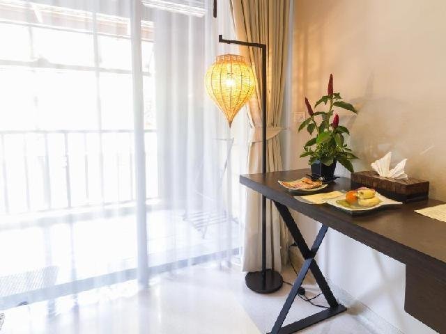 Window-side desk and hanging lamp at Buri Rasa Koh Phangan
