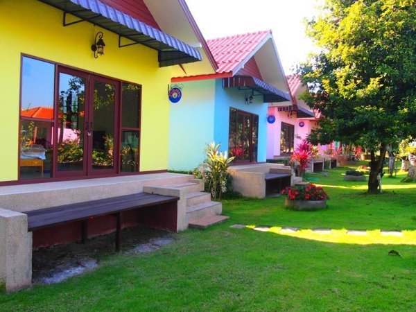 Colourful cottages facing a lawn at Donut Resort