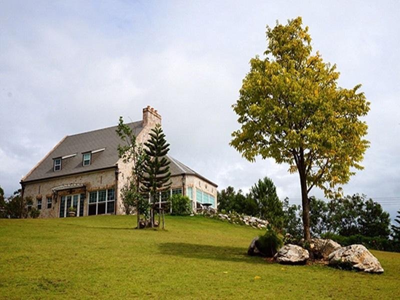 Country-style building on a sloping lawn at La Purinee Khaoyai