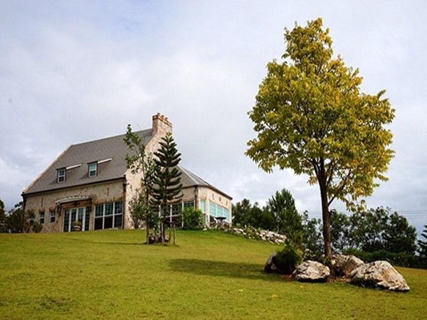 Country-style building on a sloping lawn at La Purinee Khaoyai
