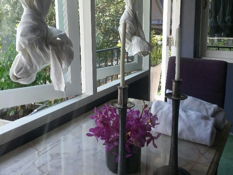 Window-side seating and plants at Le Lek Boutique Guest House