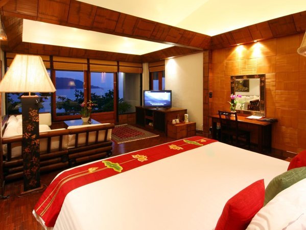 Timber-furnished guest bedroom at Mom Tri’s Villa Royale
