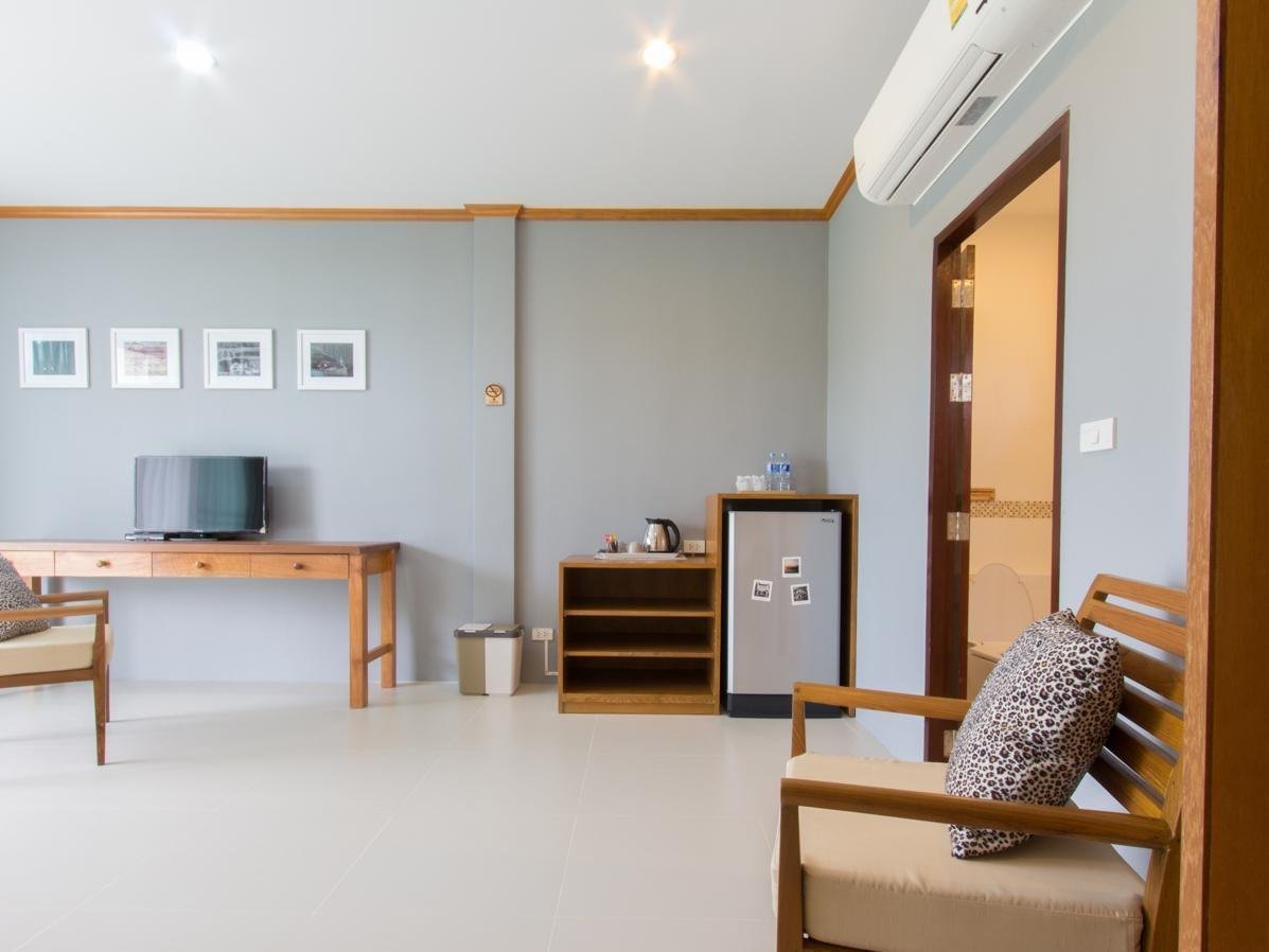 Television, desk, refrigerator and seating inside a Moonlight Cottage room