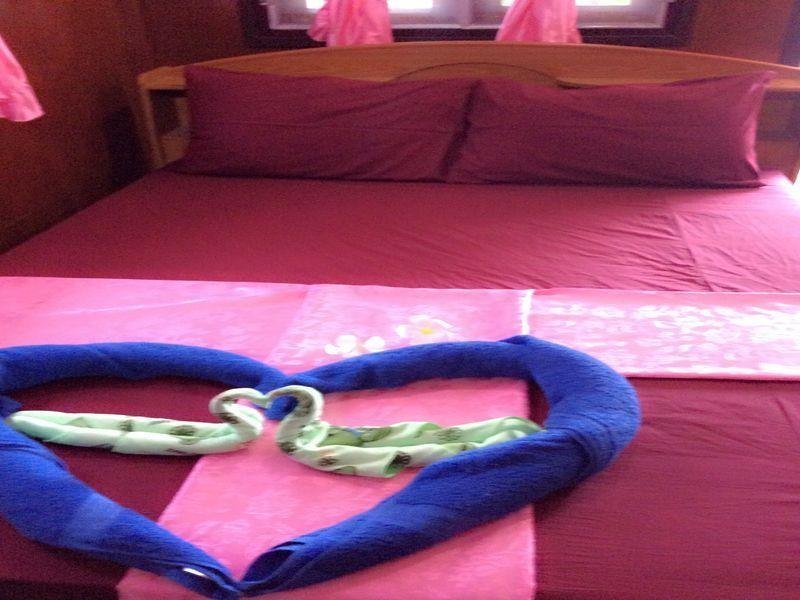 Double bed and folded-towel display at Silver Beach Bungalow
