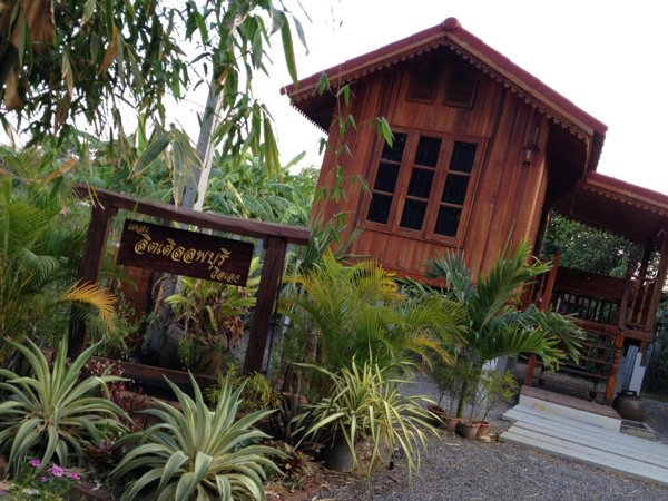Traditional wooden house beside the entrance to The Little Lopburi Village