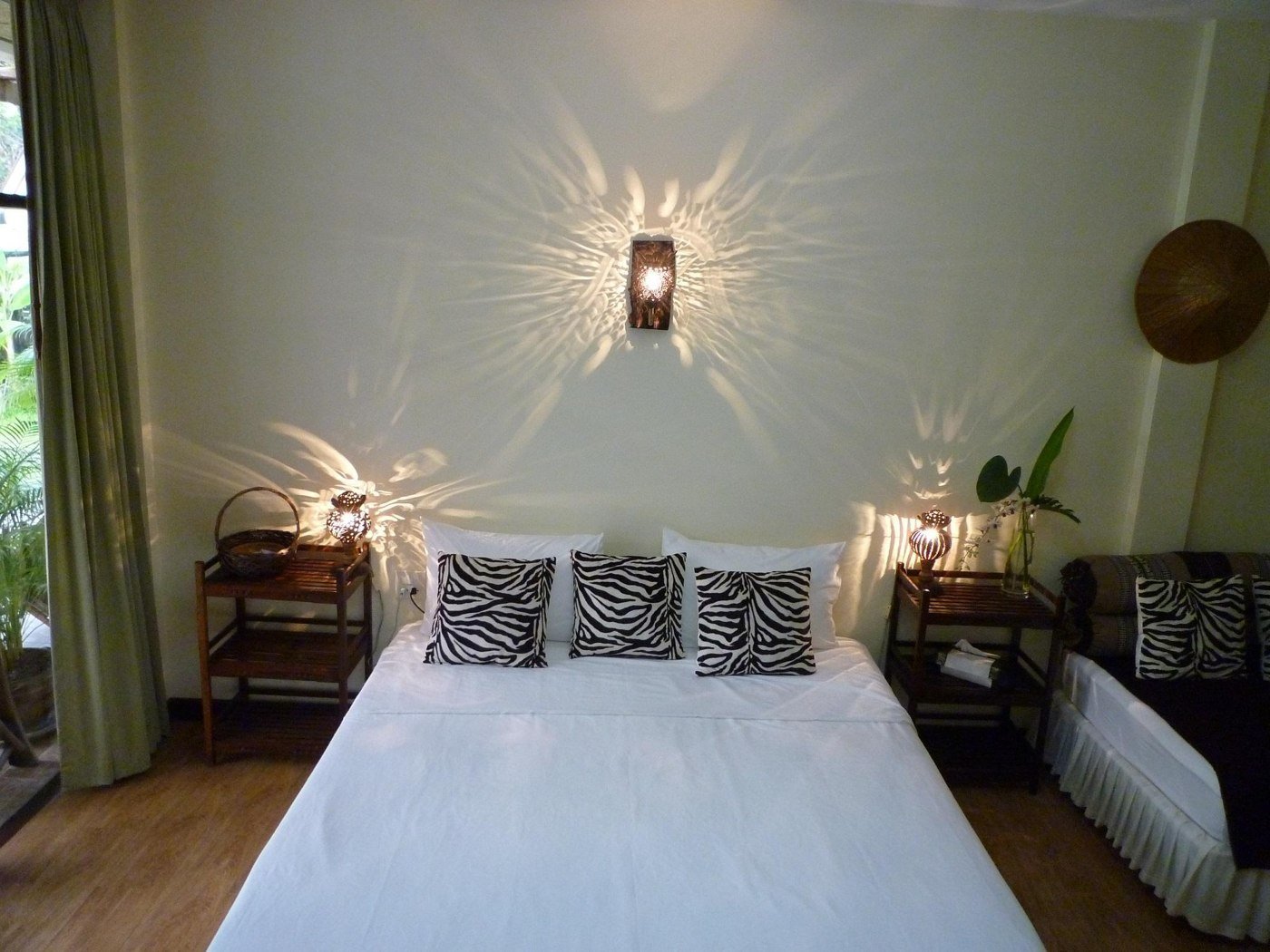 Double bed beneath decorative wall lighting at Mangrove Hideaway Koh Chang