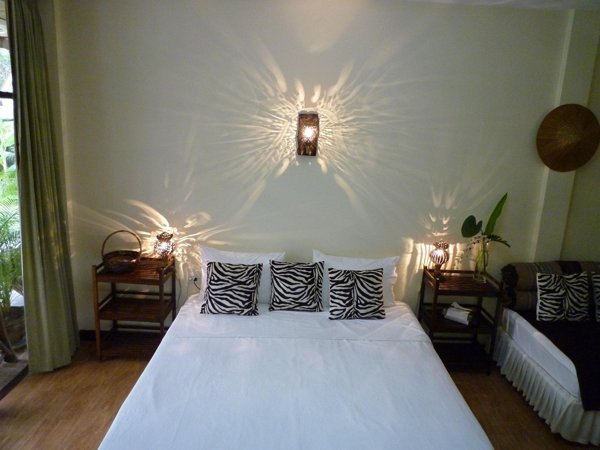 Double bed beneath decorative wall lighting at Mangrove Hideaway Koh Chang