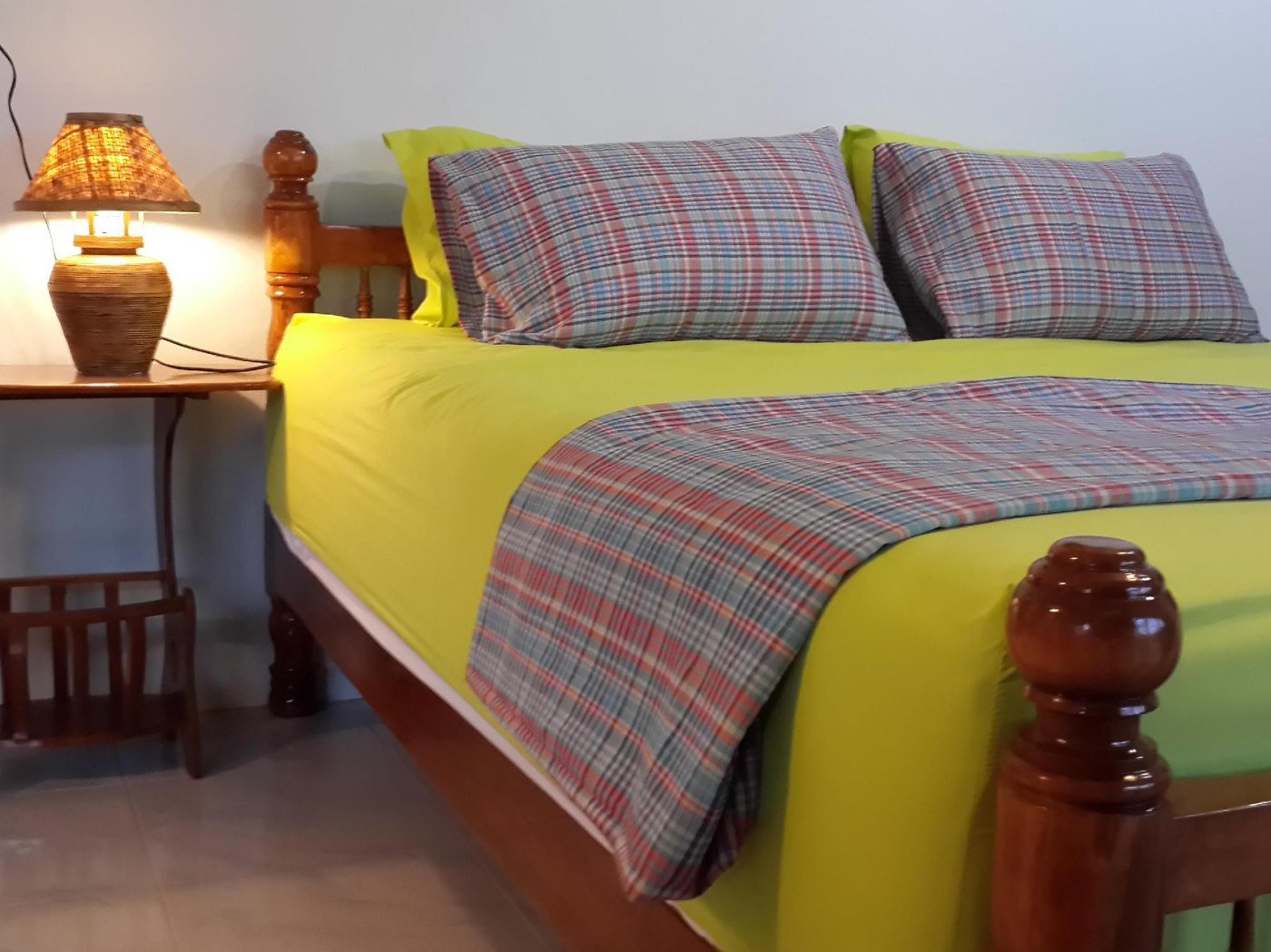 Double bed with plaid bedding at The Stay Guest House