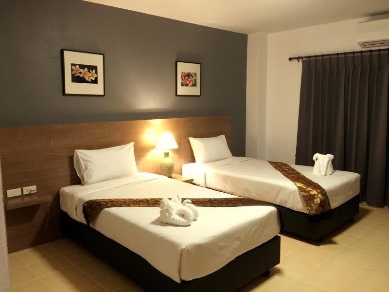 Twin bedroom with folded towels at Z-Talay House